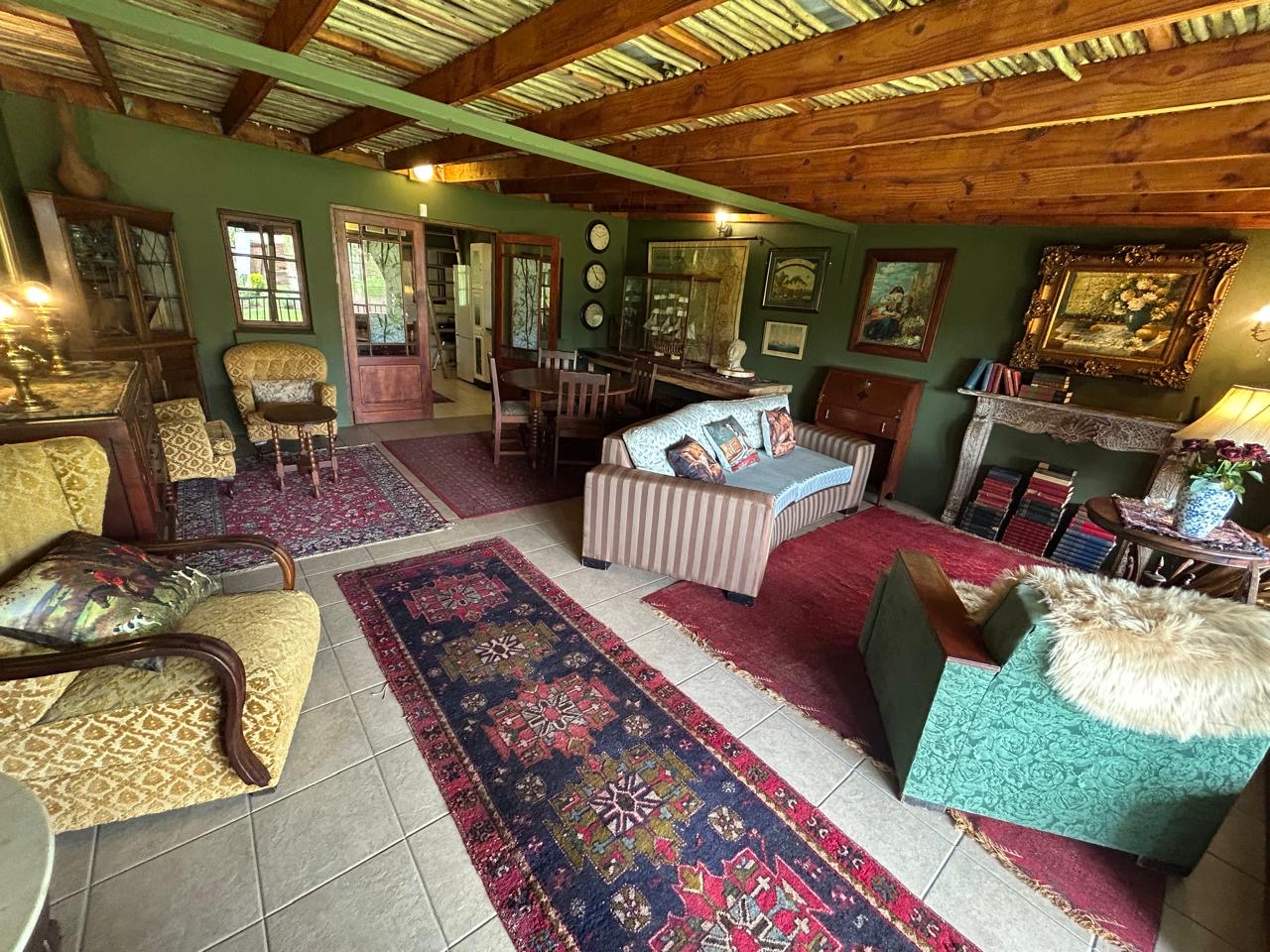 Communal lounge with sofas, armchairs, persian carpets and ornate décor