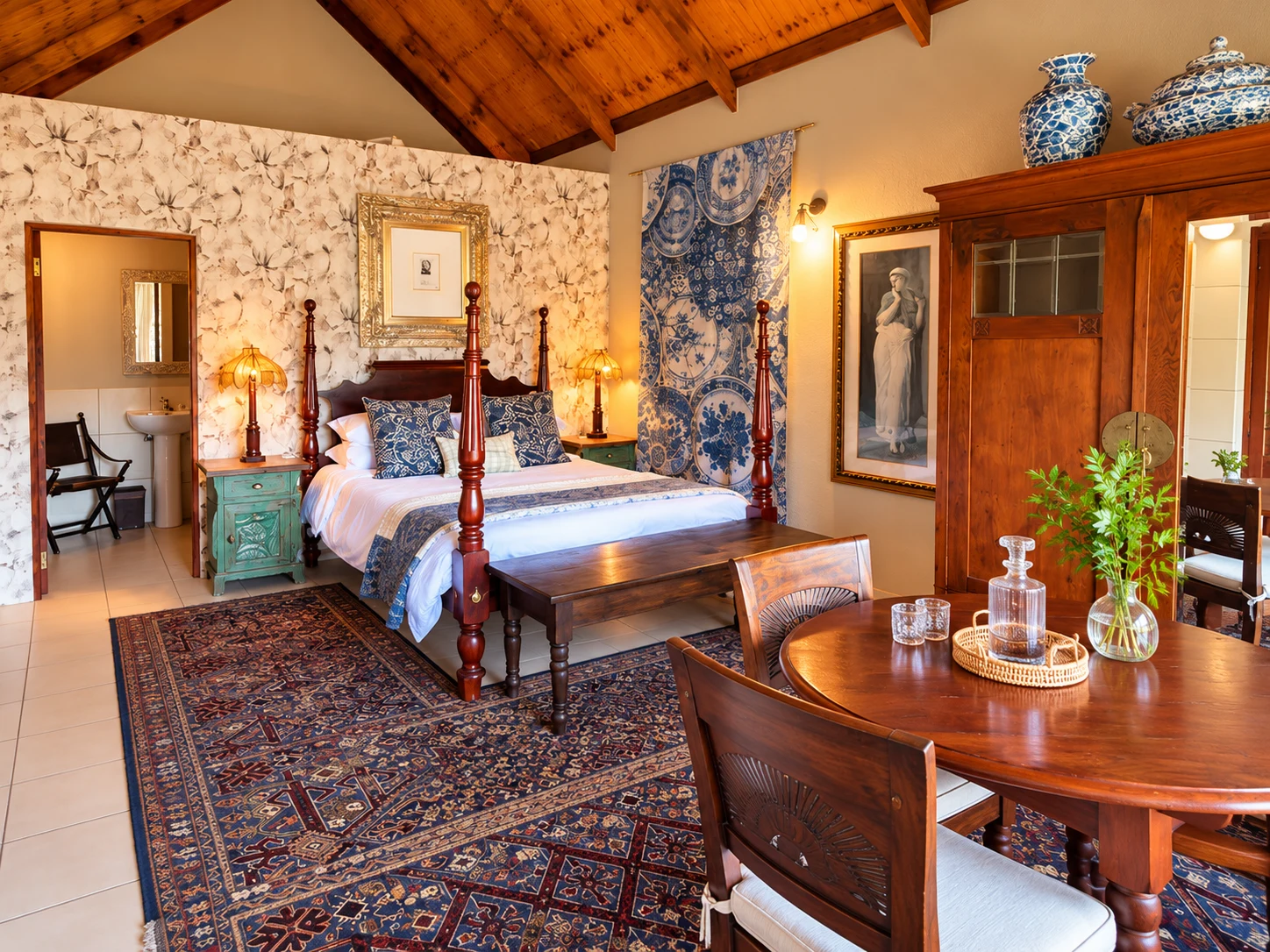 Baruch guest room with timber ceiling, four-poster bed, rugs and a wooden table