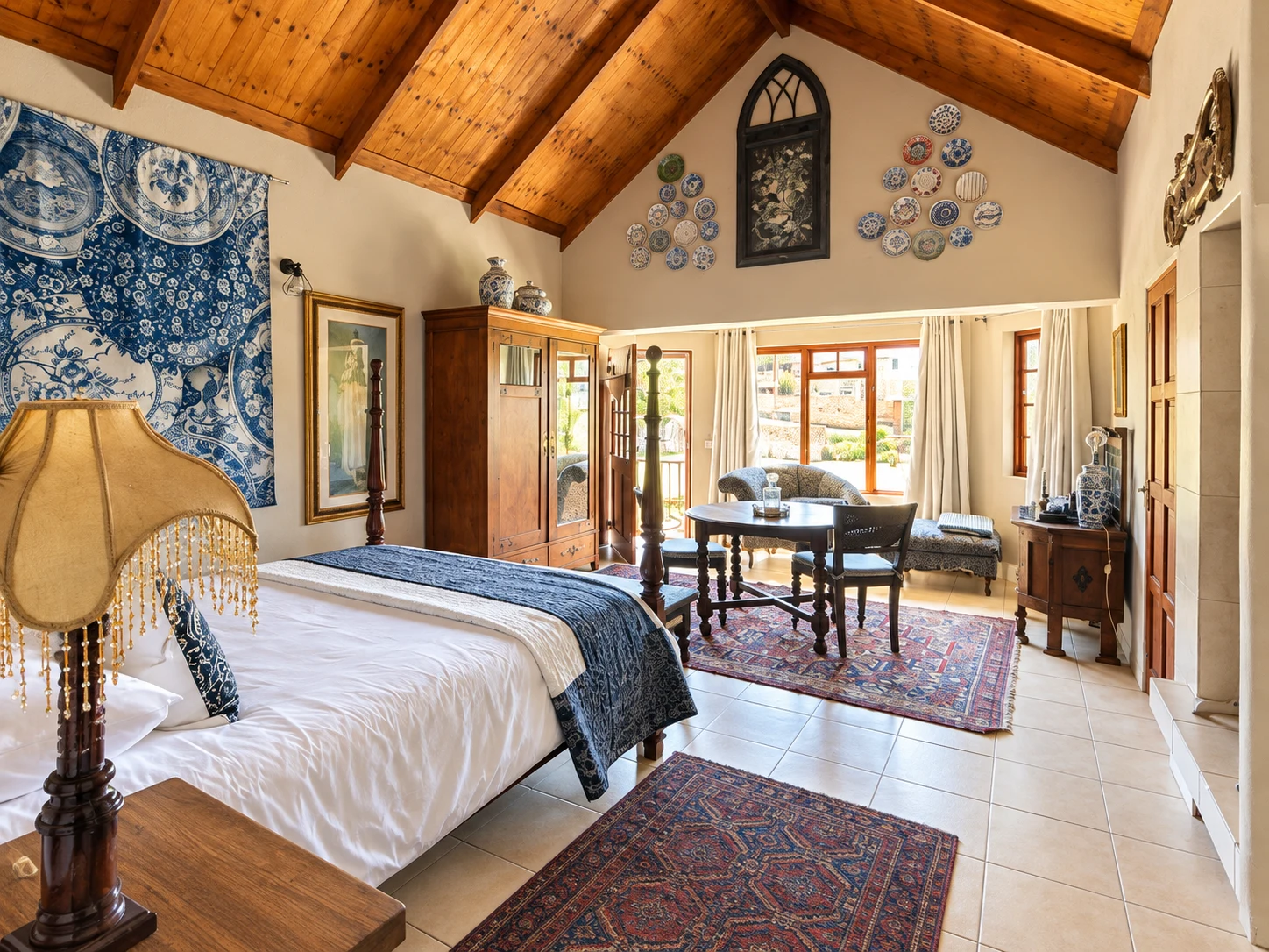 Blue and white room with a timber ceiling, table and window seating